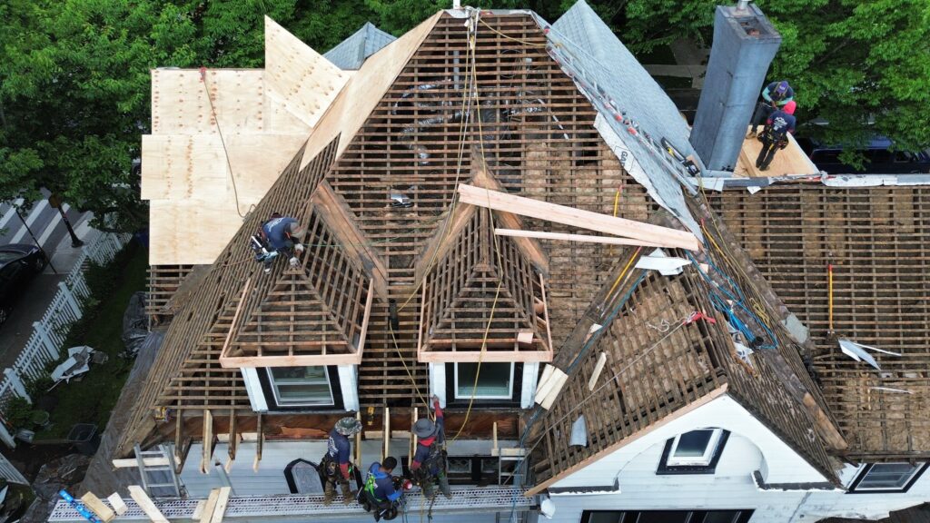 Roofers from Astoria Roofing engaged in a roof installation project