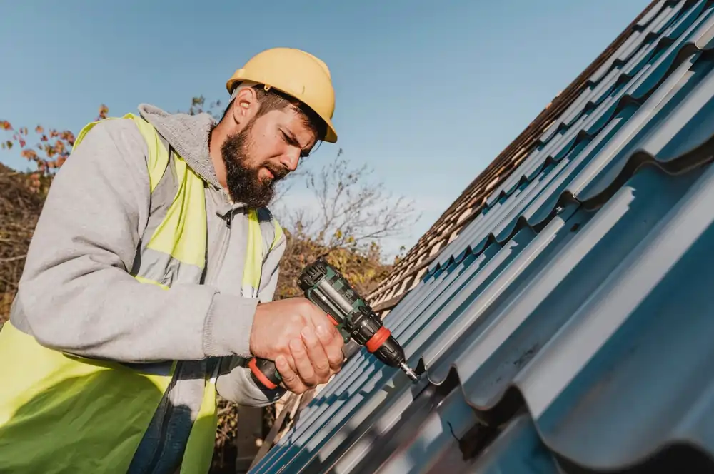 Roofer installing metal roofing panels on a house, demonstrating Prospect Heights Roofing expertise in durable roof solutions.
