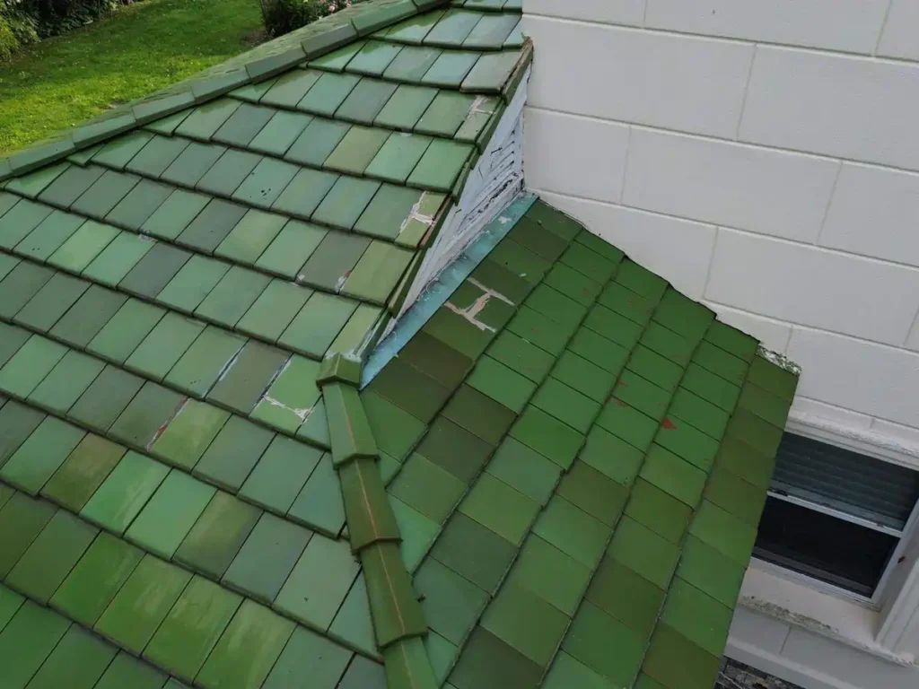 Close-up of a green tiled roof showcasing one of the most expensive roof material options, known for its durability and premium aesthetic.